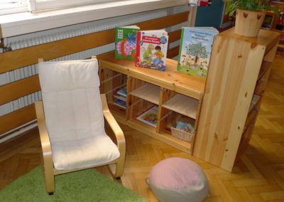 Children's group room: children's reading corner with comfortable seat and bookshelf