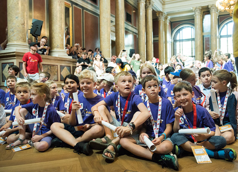 Children at the Vienna Children's University graduation show different emotions from laughter to amazement to skepticism